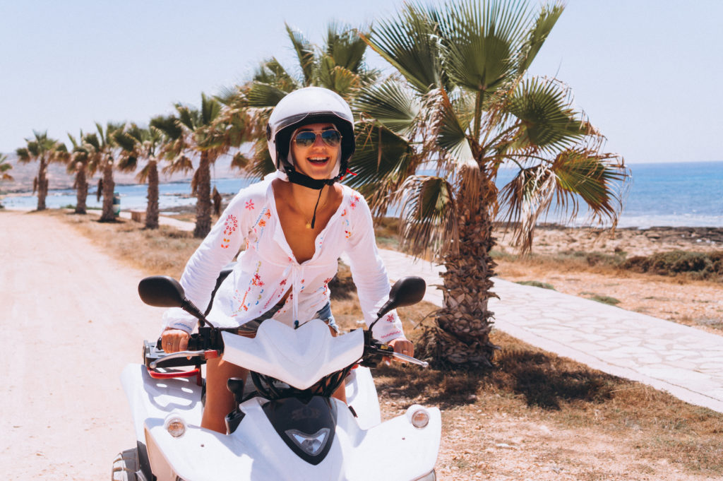 Woman travelling on quad by th ocean